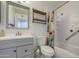 Modern bathroom with bathtub, shower, white tile, and rustic shelves at 1357 S Loma Vis, Mesa, AZ 85204