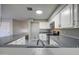 Stylish kitchen featuring white cabinets, stainless steel appliances, and patterned flooring, enhancing the home's modern appeal at 1357 S Loma Vis, Mesa, AZ 85204