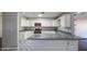 Bright kitchen with white cabinets, stainless steel appliances, stylish flooring, and modern countertops at 1357 S Loma Vis, Mesa, AZ 85204