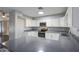 Well-lit kitchen featuring modern countertops, stainless steel appliances, white cabinetry and stylish flooring at 1357 S Loma Vis, Mesa, AZ 85204