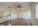 Open-concept living area seamlessly connects to kitchen, featuring wood floors, vaulted ceilings, and stylish shelving at 1357 S Loma Vis, Mesa, AZ 85204