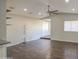 Bright living room with dark wood floors, vaulted ceilings and ceiling fan offers modern style and spacious comfort at 1357 S Loma Vis, Mesa, AZ 85204