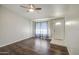 Cozy living room showcasing hardwood floors, neutral walls, natural light, and a bright white front door at 1357 S Loma Vis, Mesa, AZ 85204