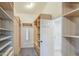 Well-organized walk-in closet featuring custom shelving and storage, enhancing functionality and maximizing space efficiency at 1357 S Loma Vis, Mesa, AZ 85204