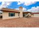 Rear exterior view showcasing the covered patio and large backyard at 1414 W Grovers Ave, Phoenix, AZ 85023