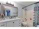 Bright bathroom featuring a new vanity, toilet, and shower-tub combination at 1414 W Grovers Ave, Phoenix, AZ 85023