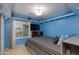 This bedroom has blue walls, a window, shelves, a TV, and a large bed at 1414 W Grovers Ave, Phoenix, AZ 85023