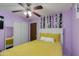 Cozy bedroom with purple walls, ceiling fan, and ample closet space at 1414 W Grovers Ave, Phoenix, AZ 85023
