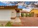 Inviting home entrance with a security door, manicured landscaping, and a two-car garage at 1414 W Grovers Ave, Phoenix, AZ 85023
