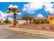 Cozy one-story home featuring a well-maintained front yard, a palm tree, and a two-car garage at 1414 W Grovers Ave, Phoenix, AZ 85023