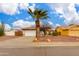 Charming home featuring a well-maintained front yard, a palm tree, and a two-car garage at 1414 W Grovers Ave, Phoenix, AZ 85023