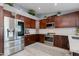 A bright kitchen featuring dark cabinets, stainless steel appliances, and a modern design at 1414 W Grovers Ave, Phoenix, AZ 85023