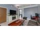 Cozy living room featuring modern furniture, a stylish media center, and an open floor plan at 1414 W Grovers Ave, Phoenix, AZ 85023