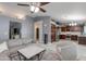 Open-concept living room with modern furnishings, a ceiling fan, and bright, light-colored wood-look floors at 1414 W Grovers Ave, Phoenix, AZ 85023
