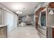 Bright, modern kitchen with wood cabinets leading into a large living room with fireplace and modern furniture at 1414 W Grovers Ave, Phoenix, AZ 85023