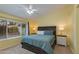 A bedroom with yellow walls, a ceiling fan, and a bed with blue and white bedding at 1414 W Grovers Ave, Phoenix, AZ 85023