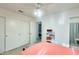 Bedroom featuring a ceiling fan, closet, and doorway leading to the ensuite bathroom at 14300 W Bell Rd # 245, Surprise, AZ 85374