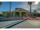 Exterior of the community center showcasing desert landscaping and convenient parking with visible signage and golf cart parking at 14300 W Bell Rd # 245, Surprise, AZ 85374