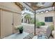 Charming courtyard with patio, storage, rock landscaping, and walkway to home's entrance at 14300 W Bell Rd # 245, Surprise, AZ 85374
