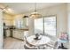 Cozy dining area with a chandelier, neutral tones, and a bright window at 14300 W Bell Rd # 245, Surprise, AZ 85374