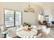 Open concept dining area with abundant natural light, tile floors, and views of the living space at 14300 W Bell Rd # 245, Surprise, AZ 85374