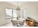 Bright dining area with a round table, four chairs, and natural light from the surrounding windows at 14300 W Bell Rd # 245, Surprise, AZ 85374