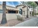 Front exterior featuring desert landscaping, mature trees, and architectural details at 14300 W Bell Rd # 245, Surprise, AZ 85374