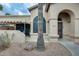 Exterior view of the property featuring a welcoming front entrance with a decorative security door and low maintenance landscaping at 14300 W Bell Rd # 245, Surprise, AZ 85374