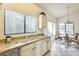 Bright kitchen features granite countertops, double sinks, and ample natural light from a large window at 14300 W Bell Rd # 245, Surprise, AZ 85374