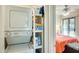 Convenient laundry area with stacked washer and dryer and shelving for storage at 14300 W Bell Rd # 245, Surprise, AZ 85374