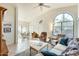 Open living area with tile floors, high ceilings, arched windows, and views into the dining room at 14300 W Bell Rd # 245, Surprise, AZ 85374