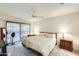 Spacious main bedroom with sliding glass door, ceiling fan, and plush carpeting at 14300 W Bell Rd # 245, Surprise, AZ 85374