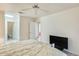 Bright main bedroom featuring a ceiling fan and doorways to the bathroom and other rooms at 14300 W Bell Rd # 245, Surprise, AZ 85374