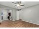 Bedroom with closet, white trim, and wood-look floors at 1432 W Emerald Ave # 648, Mesa, AZ 85202