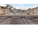 A community pool is fenced in with a pool and seating area for residence enjoyment in a condominium complex at 1432 W Emerald Ave # 648, Mesa, AZ 85202