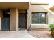 Inviting front entrance with security door, stone details, and a well-manicured garden area at 1432 W Emerald Ave # 648, Mesa, AZ 85202