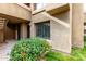 Charming exterior of a multi-story building with a private entrance surrounded by lush landscaping and colorful flowers at 1432 W Emerald Ave # 648, Mesa, AZ 85202