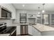 Updated kitchen featuring stainless steel appliances, white cabinets, and stylish countertops with a modern sink at 1432 W Emerald Ave # 648, Mesa, AZ 85202