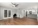 Bright living room with laminate floors, leading to a kitchen with stainless appliances and a glass-paned door at 1432 W Emerald Ave # 648, Mesa, AZ 85202