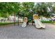 Community playground with slides and climbing features in a well-maintained play area and trees at 1432 W Emerald Ave # 648, Mesa, AZ 85202