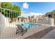 Community pool with lounge chairs and perimeter fencing at 1432 W Emerald Ave # 648, Mesa, AZ 85202