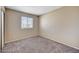 Cozy bedroom with neutral colors, carpet, closet, and a window allowing natural light at 14414 N Boxwood Ln, Fountain Hills, AZ 85268