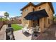 Expansive backyard featuring lush artificial turf, a paved patio area, and a built-in BBQ grill at 14733 N 159Th Dr, Surprise, AZ 85379
