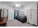 Well-lit bedroom boasting a daybed, ceiling fan, and functional wardrobe for a cozy and inviting space at 14733 N 159Th Dr, Surprise, AZ 85379