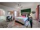 Stylish bedroom with unique décor, including a textured wall feature, creating a chic and comfortable space at 14733 N 159Th Dr, Surprise, AZ 85379