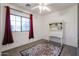 Bedroom features a window with red curtains, white walls, and a decorative writing desk at 14733 N 159Th Dr, Surprise, AZ 85379