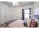 Bright bedroom with large window, closet, and comfy bed creates a serene and inviting retreat at 14733 N 159Th Dr, Surprise, AZ 85379