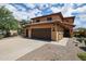Beautiful two-story home with desert landscaping, tile roof, and a welcoming covered porch at 14733 N 159Th Dr, Surprise, AZ 85379