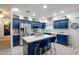 Charming kitchen featuring blue cabinets, stainless steel appliances, and a functional island at 14733 N 159Th Dr, Surprise, AZ 85379