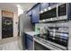 Kitchen featuring blue cabinets, stainless steel appliances, and an adjacent pantry at 14733 N 159Th Dr, Surprise, AZ 85379